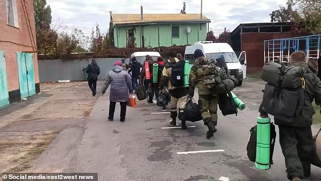 Mobilized Russian troops are seen heading to the front.