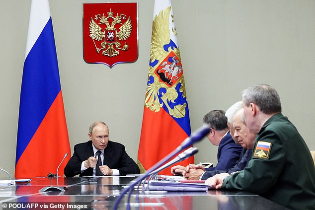 Russian President Vladimir Putin (L) chairs a meeting on the situation in the Kursk region, at his residence in Novo-Ogaryovo, outside Moscow, August 12, 2024.