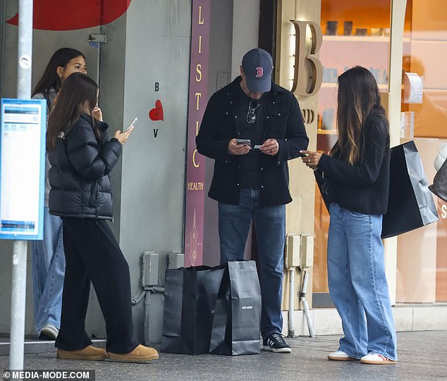 He proved to be a very doting father when he took his two youngest daughters, Gia, 16, and Stella (both left), 13, shopping on a cloudy day in Sydney.