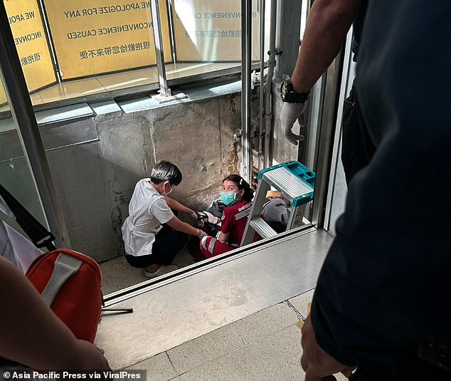 Doctors work at the base of the elevator shaft in the departure terminal at Suvarnabhumi International Airport in Bangkok