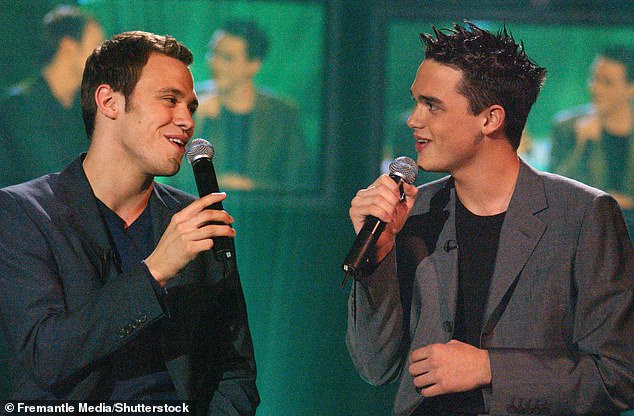 The star also revealed that attempts to cover up his sexuality continued later in his career (pictured with Gareth Gates on Pop Idol 2002).