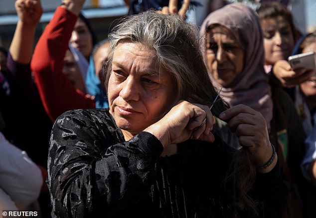 Women cut their hair in protest against the Iranian government after the death of Amini