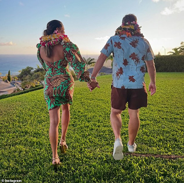 She added an adorable photo of her and Nick holding hands as they walked into the sunset.