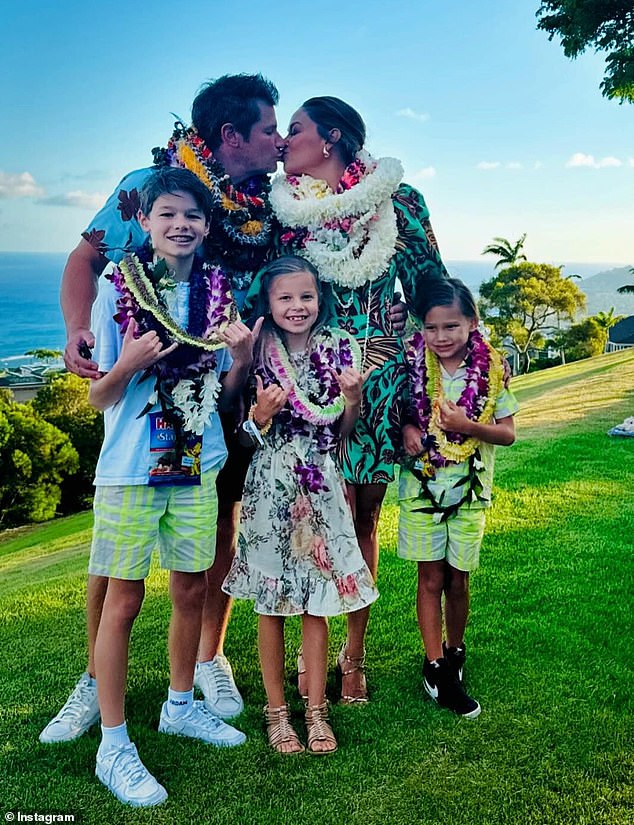 She shared a carousel of photos of herself, husband Nick, 50, and their children Camden John, 11, Brooklyn Elisabeth, 9, and Phoenix Robert, 7, posing in Hawaiian-themed ensembles and flower leis.