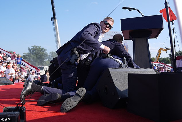 Secret Service agents rushed onto the stage and pushed Trump to the ground after shots were fired.