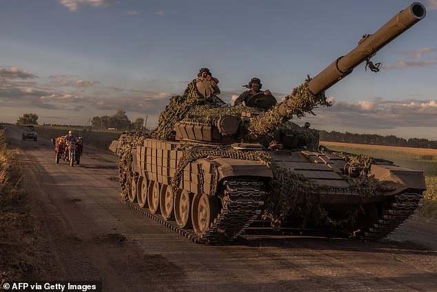 Ukrainian military personnel operate a Soviet-made T-72 tank in the Sumy region near the border with Russia on August 12, 2024, amid Russia's invasion of Ukraine.