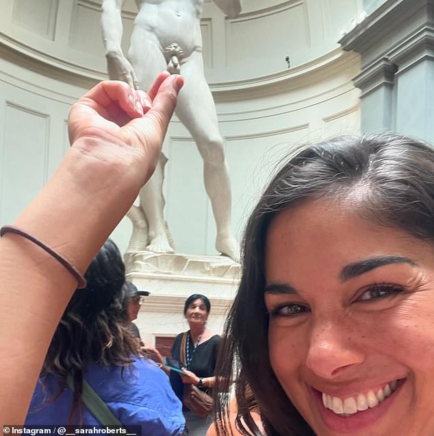 The Melbourne-born actress struck a suggestive pose, placing her fingers vertically over the statue's private parts, giving the impression that she was touching them.