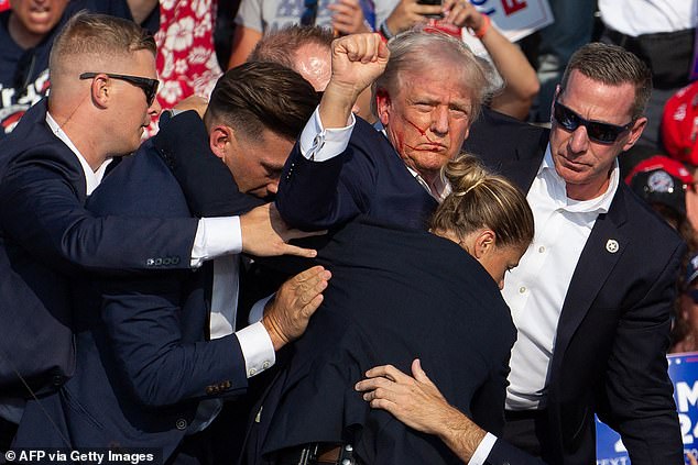 Sources suspect Trump's actions could be due to post-traumatic stress disorder or some other traumatic response to the assassination attempt at his rally in Butler, Pennsylvania, last month. Trump is pictured after being shot at the July 13 rally while being escorted by Secret Service agents.