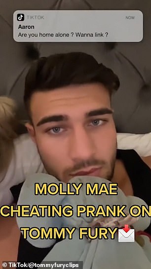 In the video, Molly-Mae pretends to try a camera filter on Tommy's face, but at the top of the screen a message appears from someone named 