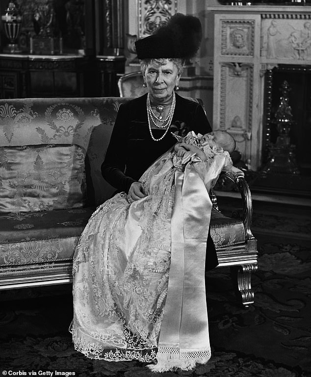 Queen Mary, The Queen Mother, holds her great-grandson, Prince Charles, after his christening at Buckingham Palace.