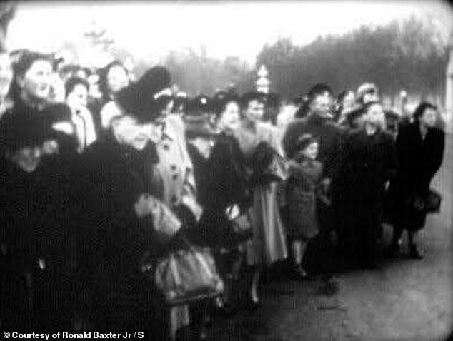 Images show a crowd of people standing outside Buckingham Palace hoping to catch a glimpse of the then Prince of Wales.