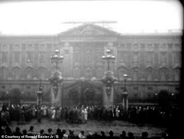 Rare footage shows clips of crowds gathering outside Buckingham Palace.