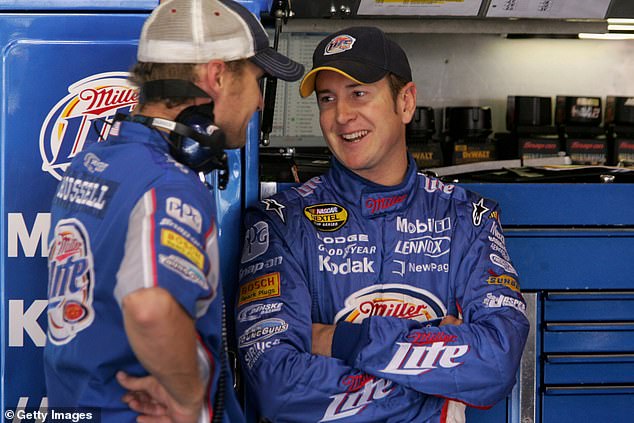 A crew member talks with driver Kurt Busch at Martinsville Speedway in 2006