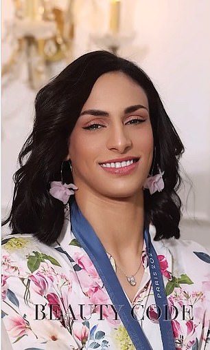 She poses in a pink floral outfit and matching earrings.