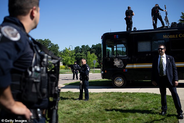 Secret Service keeps a close watch on a news conference as Vice Presidential candidate J.D. Vance speaks at the Shelby Township Police Department on August 7, 2024 in Shelby Township, Michigan. Vance and Harris spoke at competing events