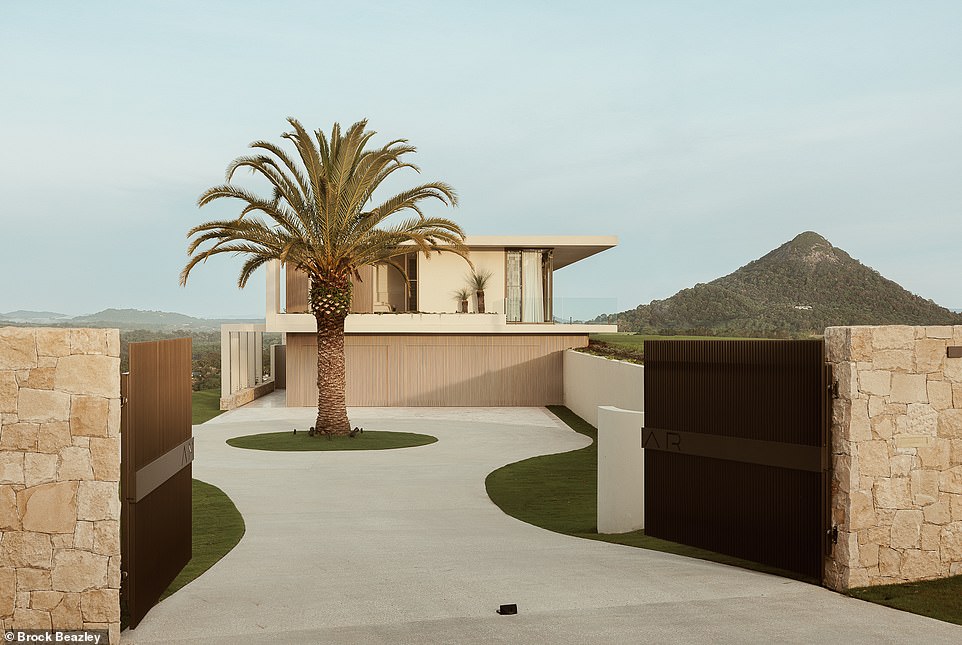 A date palm greets you as you walk up the circular driveway and gaze at the impressive structure of the house.