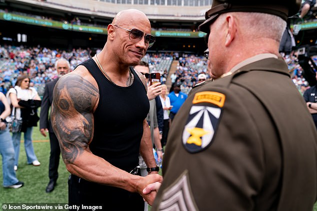 UFL owner Dwayne 'The Rock' Johnson shakes hands with servicemen and women before a UFL game