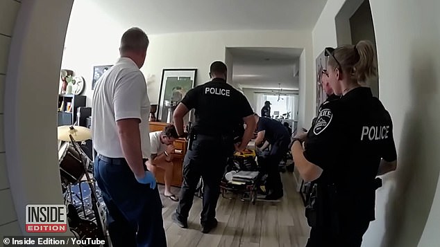 Paramedics tend to Scholtes' two-year-old daughter after she was left in a hot car for three hours while her father played video games.