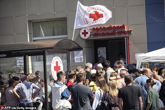 People displaced by war receive humanitarian aid at a distribution point of the Russian Red Cross in Kursk on August 15, 2024.