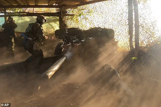 In this still taken from a video released by the press service of the Russian Defense Ministry on Friday, Aug. 16, 2024, a Russian soldier fires a Rapira anti-tank gun, in the border area of ​​the Kursk region, Russia.