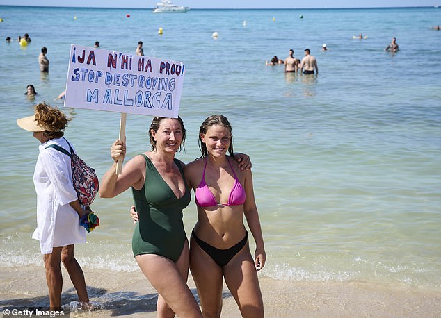 Members of the Mallorca Platja Tour association demonstrate against the tourist saturation on the beach of Palma de Mallorca