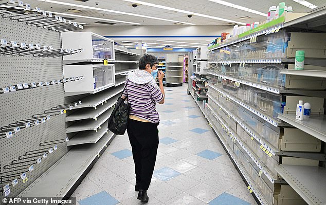 A woman browses the shelves of a Rite Aid supermarket in Alhambra, California, on Oct. 18, 2023. The store was scheduled to close within days after announcing bankruptcy on Oct. 15.