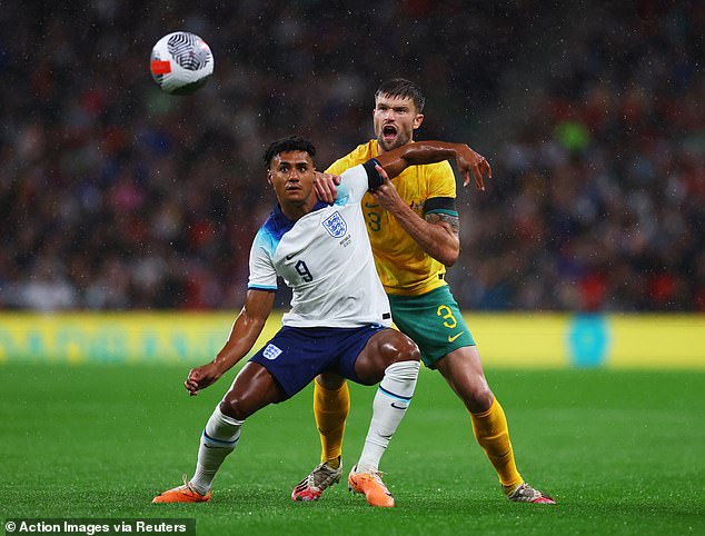 Australian Cameron Burgess, pictured battling with England's Ollie Watkins, is also a member of the Ipswich Town squad.