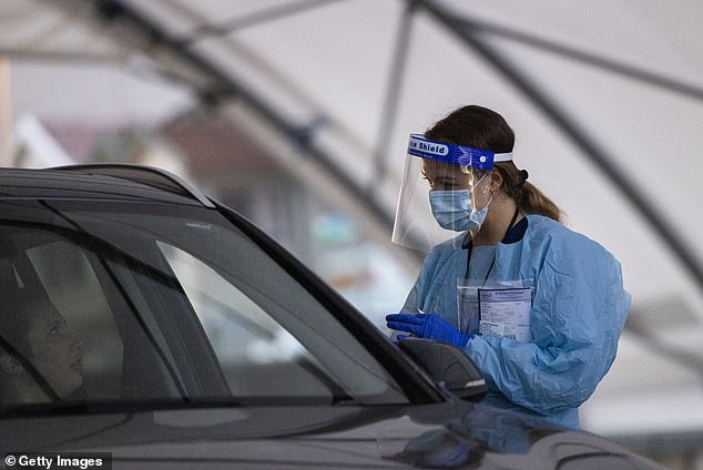 Queensland's Chief Health Officer John Gerrard said the level of childhood vaccination rates began to plummet at the end of the public health response to the Covid pandemic. An Australian health worker is pictured wearing personal protective equipment