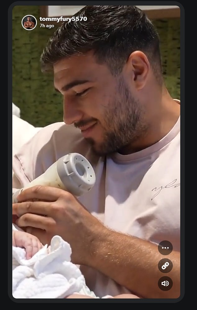 Tommy looked like a happy father in a photo posted to Snapchat on Wednesday, bottle-feeding his daughter at his £4million Cheshire mansion.