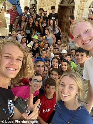 The jet-setter is seen here in Ma'aloula, Syria, with friends Philipp Buehl and Sophia Seidl.