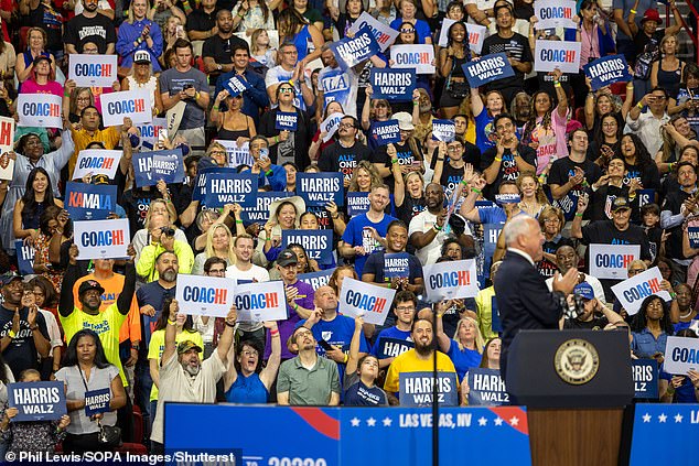 Supporters of Harris and vice presidential candidate Minnesota Gov. Tim Walz hold signs during a campaign rally at the Thomas & Mack Center in Las Vegas