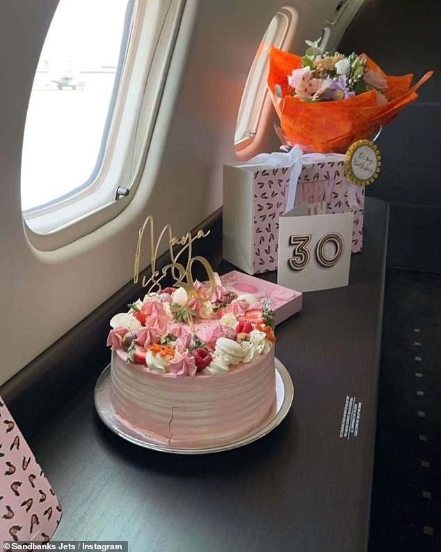 Gifts including a bouquet of flowers and a cake were seen on board.