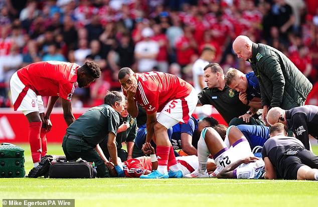 His teammate Murillo is pictured (centre) covering his mouth as he looks away after getting a close-up look at Danilo's left leg.