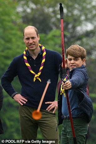 Prince George tries his hand at archery as he takes part in Big Help Out, during a visit to the Upton Scouts' third hut in Slough, west London, on May 8, 2023.