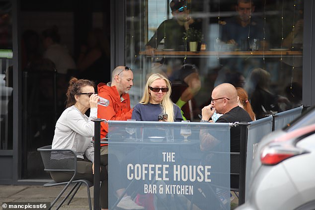 Millie then placed her dark glasses over her eyes and leaned back in her seat while sunbathing with a cold drink.