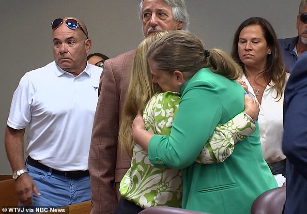 Lissette hugs family and supporters, including neighbors, in the courtroom