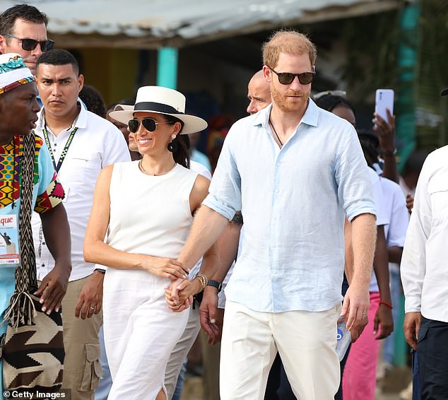 Meghan wore a white linen skirt, a sleeveless blouse and a panama hat, while Harry wore a blue linen shirt.