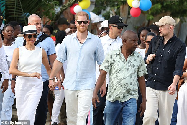 Meghan and Harry walk through the streets of San Basilio de Palenque in Colombia