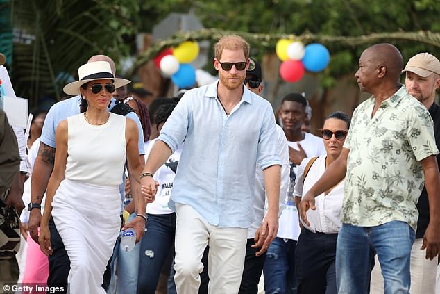 The couple was surrounded by people as they walked through the streets of San Basilio de Palenque.