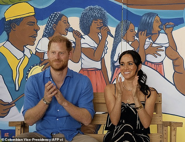 Harry and Meghan applaud during a performance at the La Boquilla drum school in Cartagena