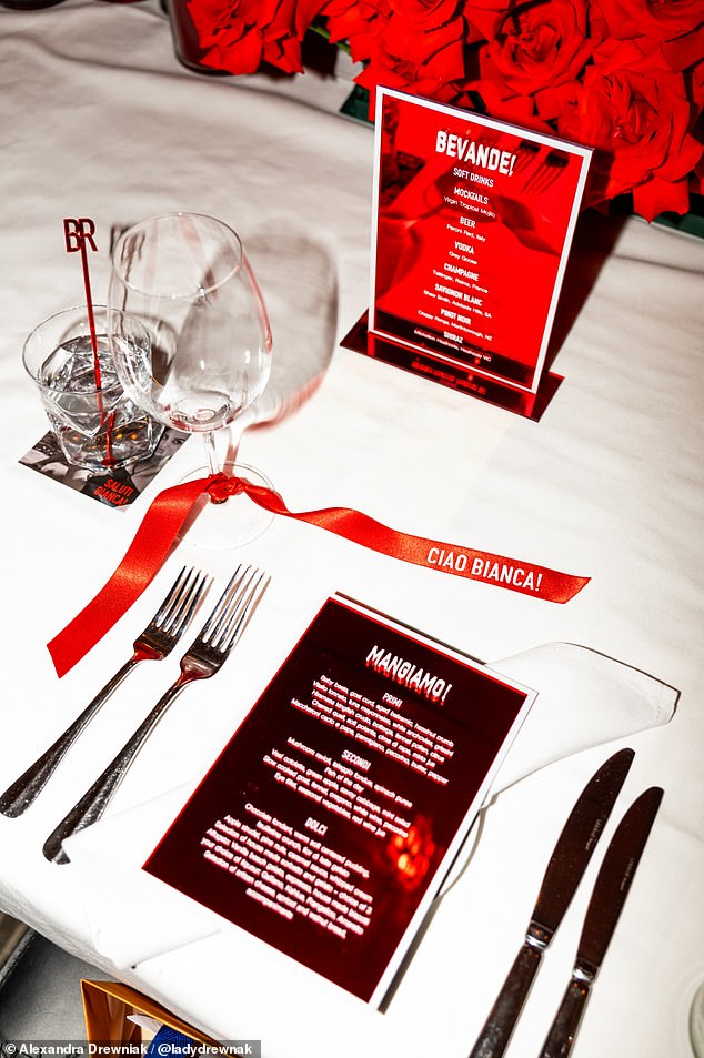 The tables were adorned with vibrant red roses, and the menu, printed in deep red, offered a selection of Italian delicacies under titles such as 'Mangiamo!' and 'Bevande!'