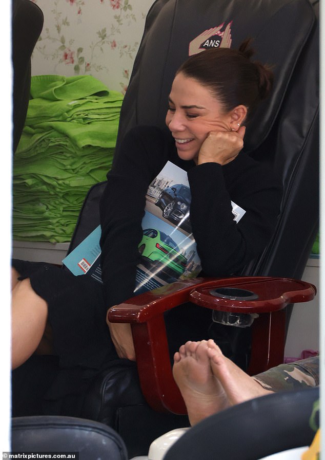 The former Home and Away star turned radio presenter was sitting comfortably in a massage chair as she had a manicure and pedicure at a nail salon.