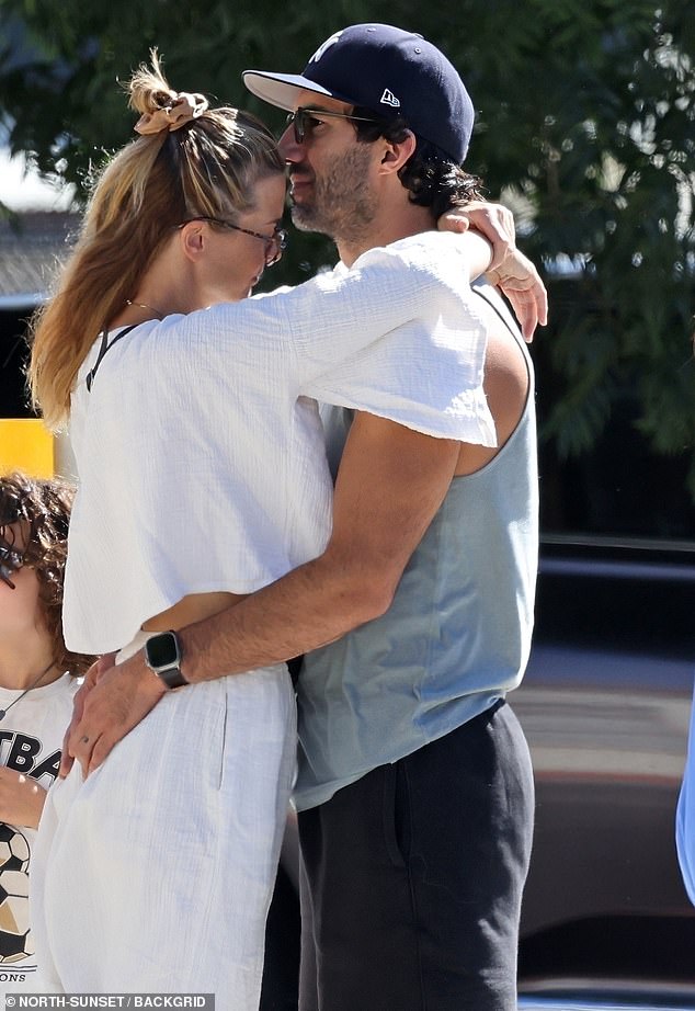 Justin Baldoni was spotted on Saturday sharing a lingering kiss with his wife Emily amid the fallout from behind-the-scenes tensions during the production of It Ends with Us.