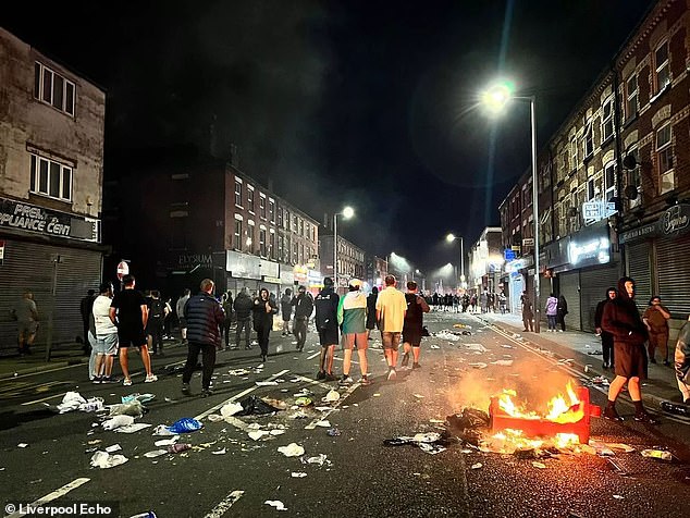 Other posts showed an image of the County Road mosque in Liverpool and an image of a burning car in Sunderland. Pictured: Riots on County Road, Liverpool