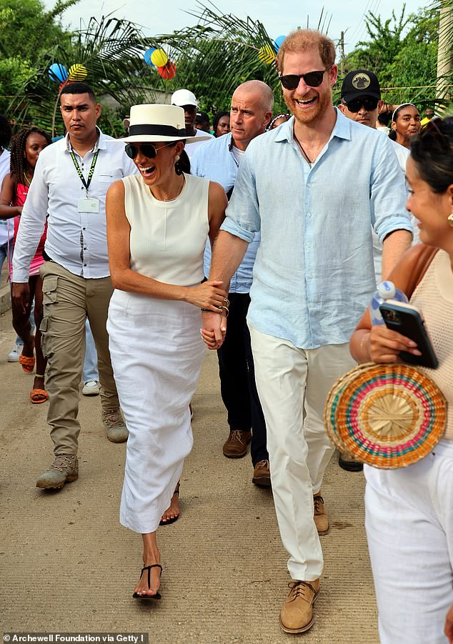 Meghan Markle and Prince Harry looked very much in love as they held hands while visiting the traditional Afro-Caribbean village, San Basilio de Palenque, on Saturday.