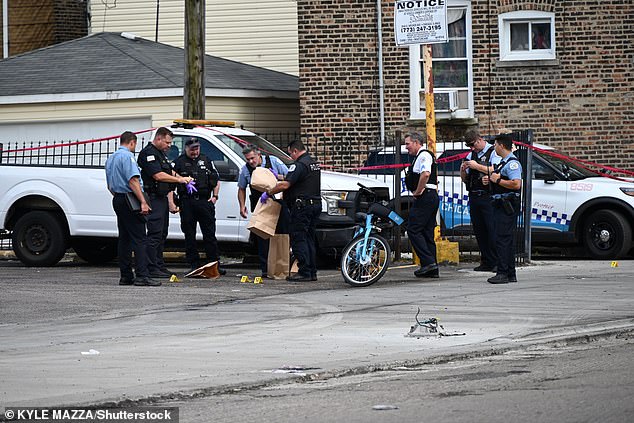 Officers were seen at the scene of a daylight shooting in Chicago on Saturday afternoon, where they treated one of at least 11 shooting victims who were shot over the weekend: 3 fatally