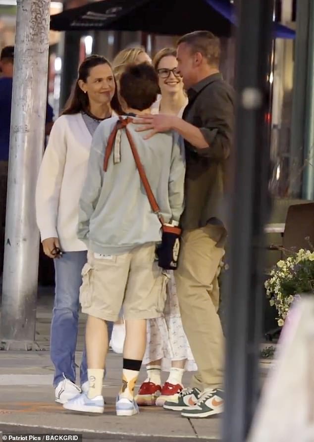 The four of them met on a sidewalk after dinner.