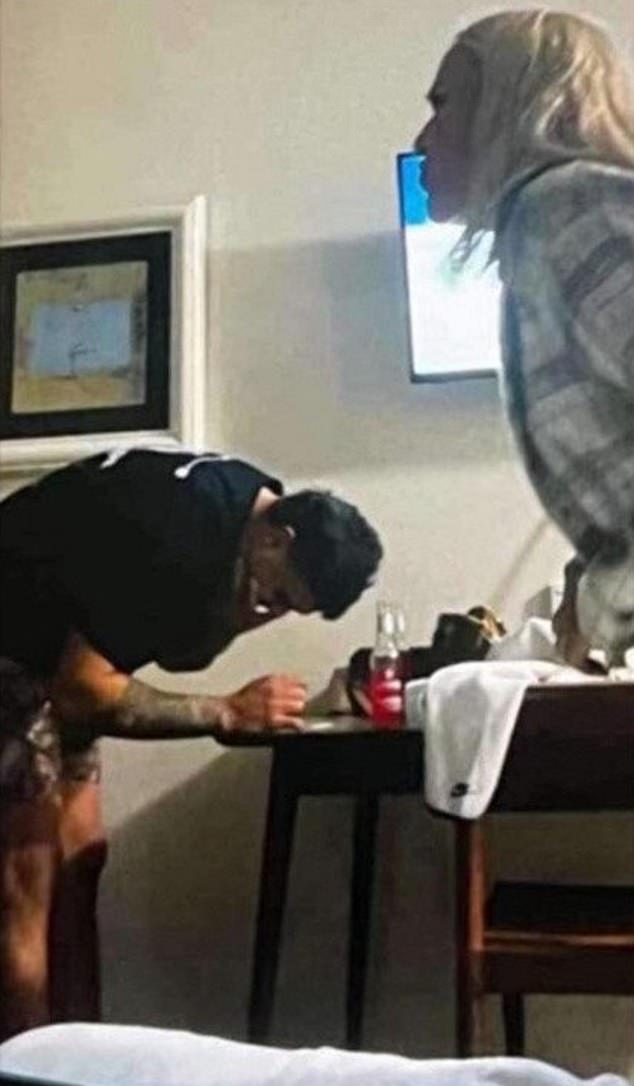 Mitchell is expected to receive a one-match suspension and fine from the NRL for bringing the game into disrepute over the image, which appears to show him leaning over a table with an unknown white substance on it while Brown stands in the foreground (pictured).