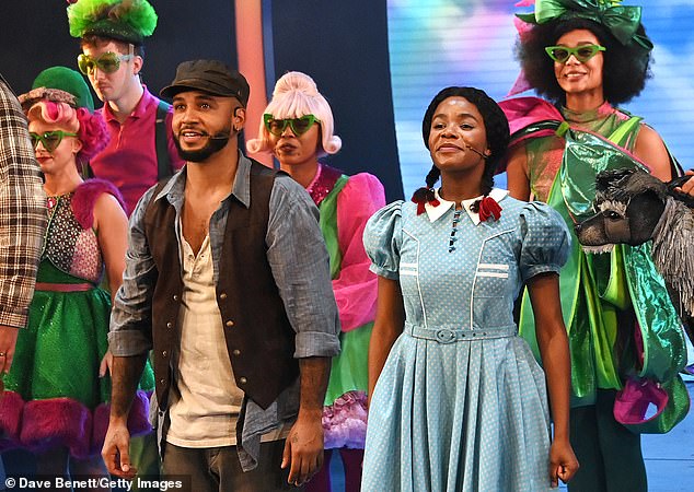 Aston looked out at the audience smiling as he and the rest of the cast lowered the curtain and the audience applauded.