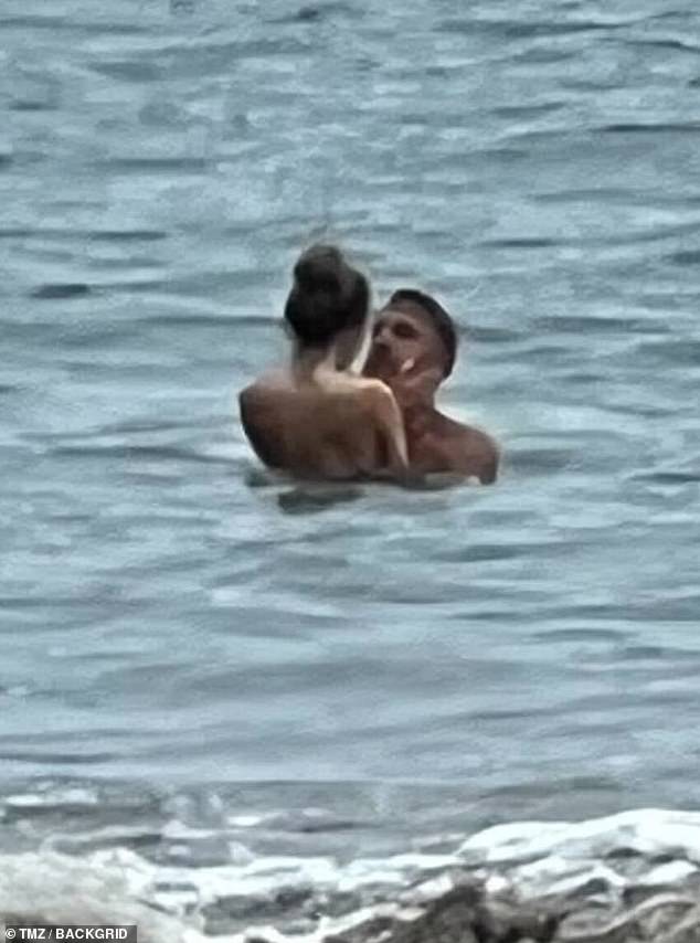 The couple seemed to be enjoying a private moment alone in the waves.